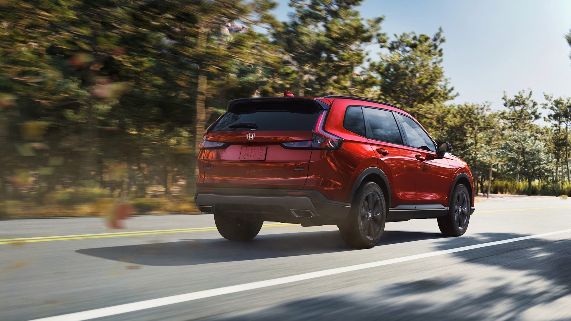 A red Honda CR-V driving down the road