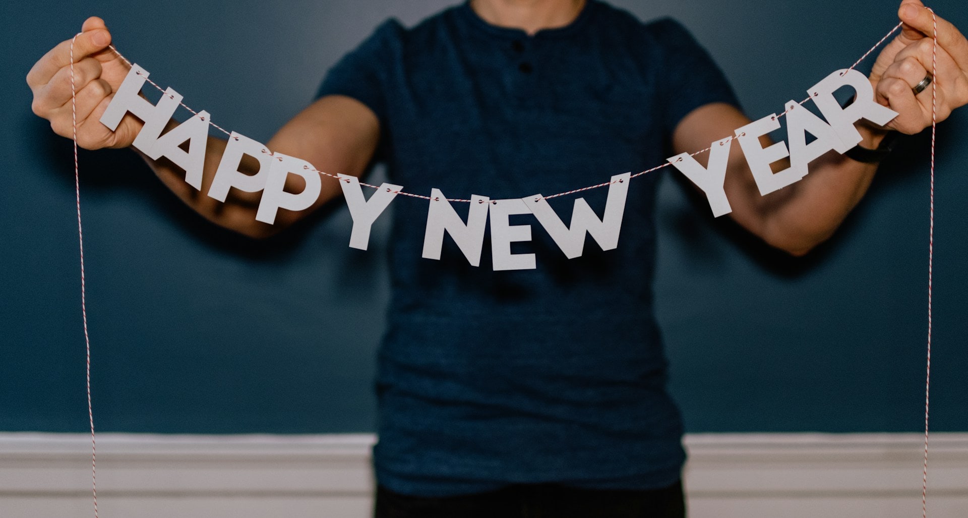 person holding garland that spells HAPPY NEW YEAR