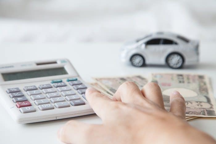 calculator, toy car, and cash