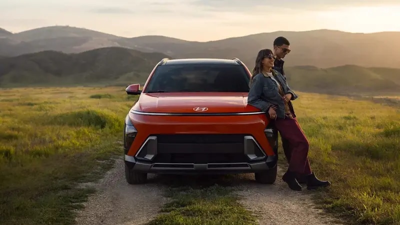 2026 Hyundai Kona parked on dirt road with couple