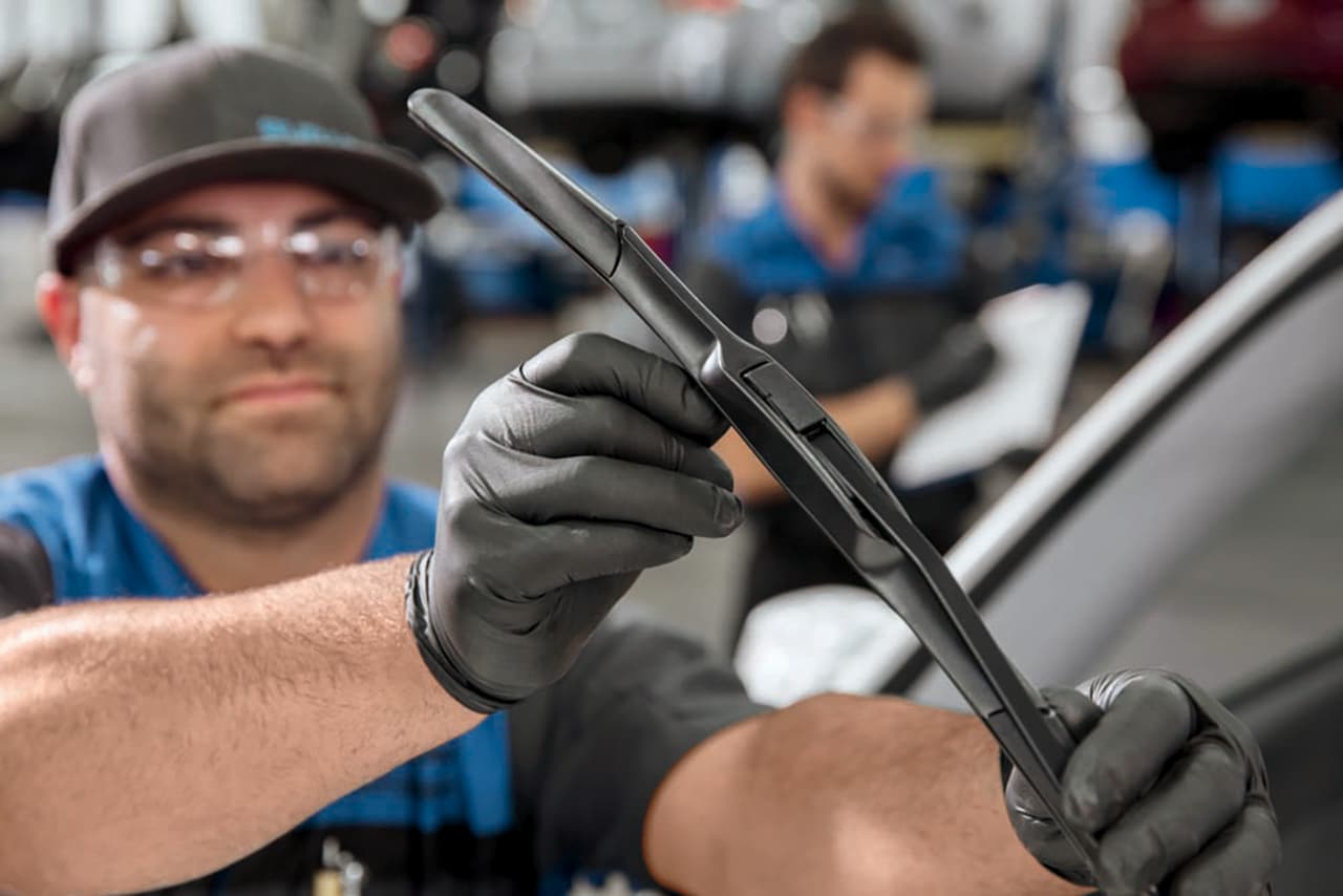 Subaru technican installing new wiper blades