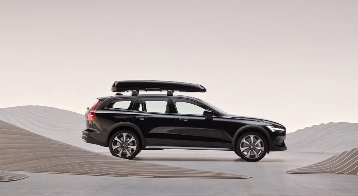2025 Volvo V60 Cross Country wagon, black, with a roofbox