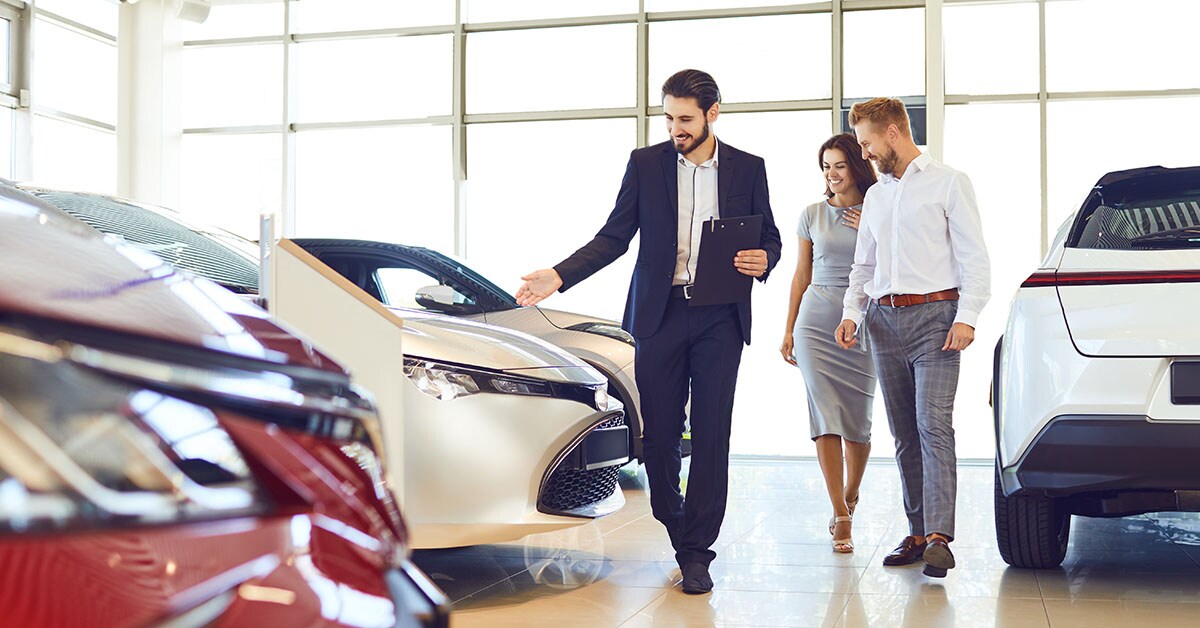 Subaru customer service representative showing car to customer.
