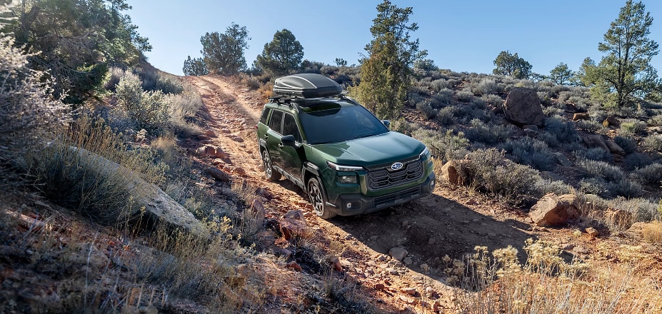 2026 Subaru Outback driving down the side of a dirt hill.