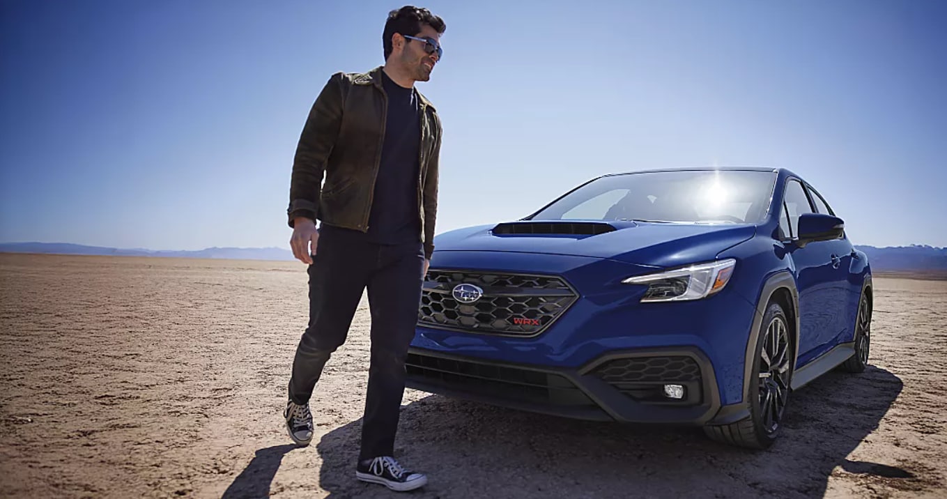 Blue 2026 Subaru WRX in Sioux City, IA parked in the desert with man walking away from vehicle.