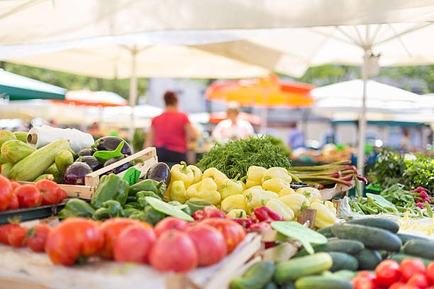 basket of fruit and vegetables and a farmers market booth