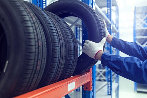 Chevy service technician picking out new tires to prevent hydroplaning