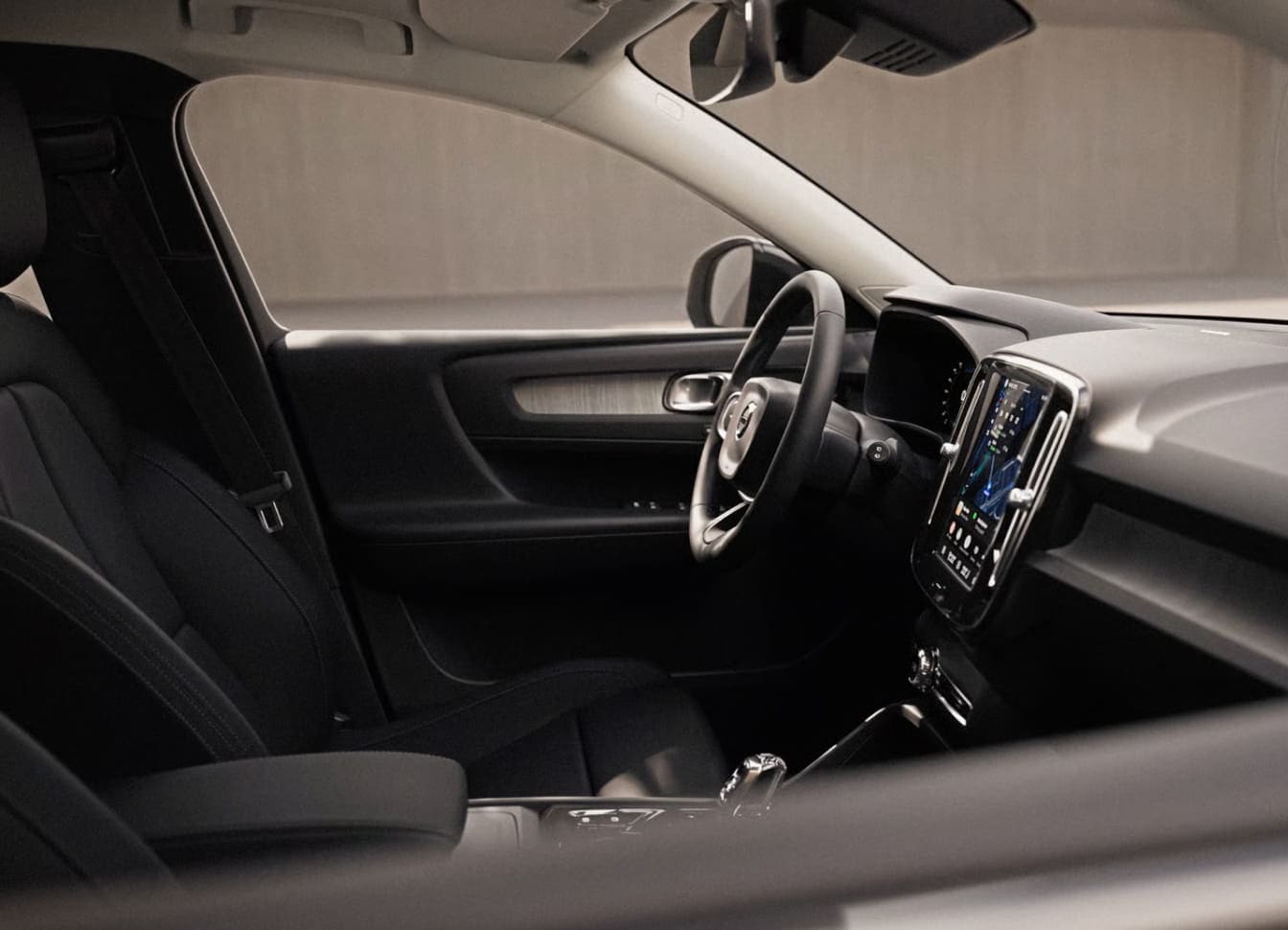 2026 Volvo XC40 interior with black leather seats, modern dashboard featuring a large touchscreen, and a refined steering wheel.