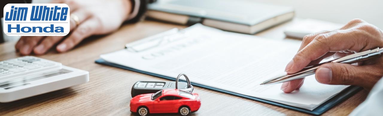 Customer consulting with leasing specialist at Jim White Honda dealership near Toledo, Ohio