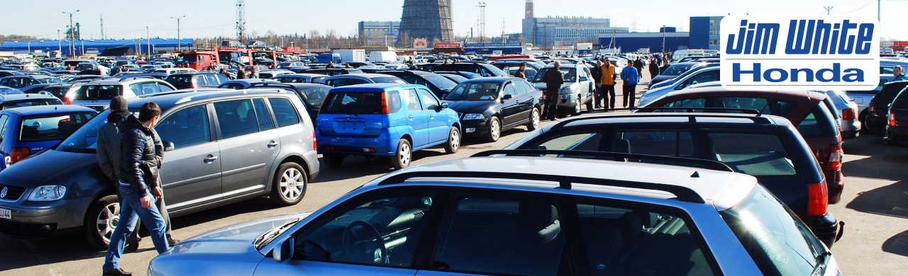 Appraiser at Jim White Honda inspecting a pre-owned vehicle during the car sale process