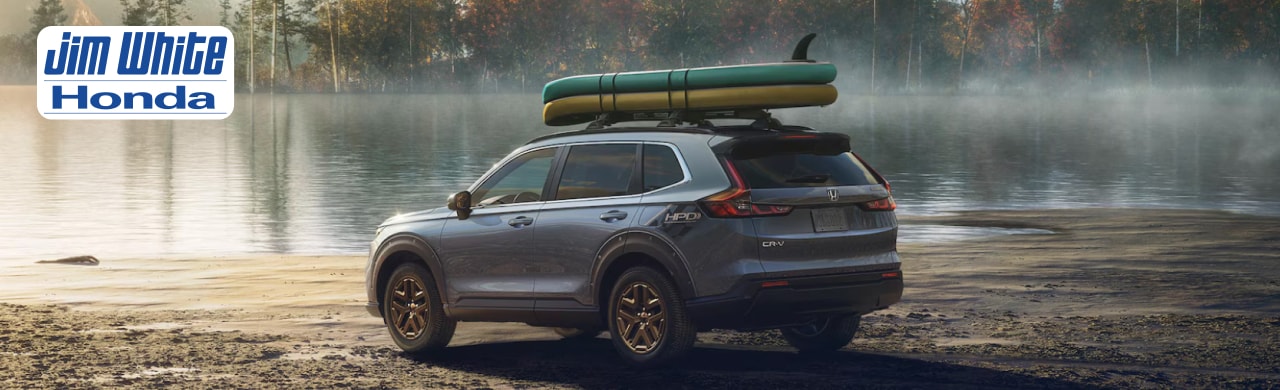 2026 Honda CR-V Hybrid Sport driving through a suburban Maumee, Ohio, neighborhood