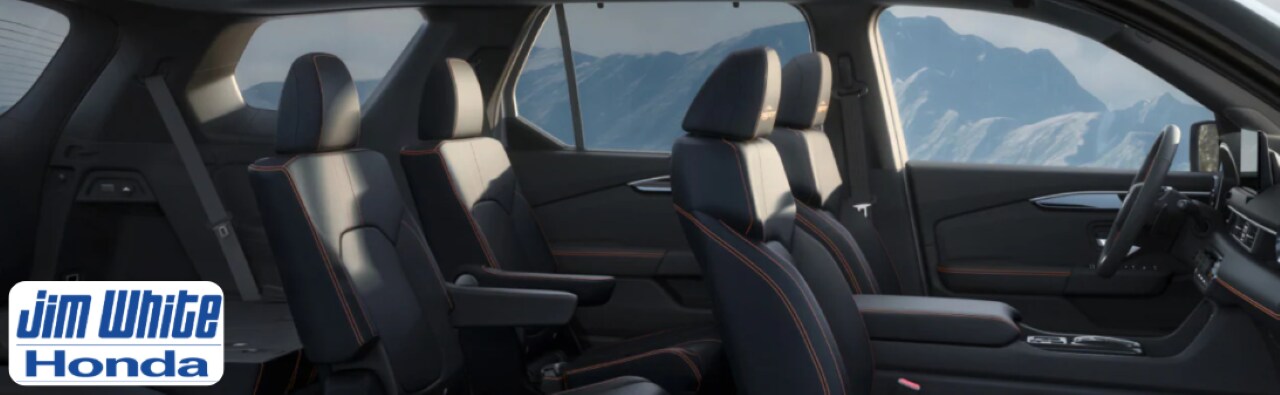 Interior of the 2026 Honda Pilot Touring highlighting leather seats, panoramic sunroof, and infotainment system.