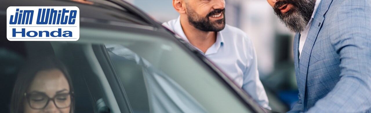 Affordable%20Automotive%20Leasing%20Options%20at%20Jim%20White%20Honda.png A customer signing lease paperwork at a dealership in Toledo, Ohio