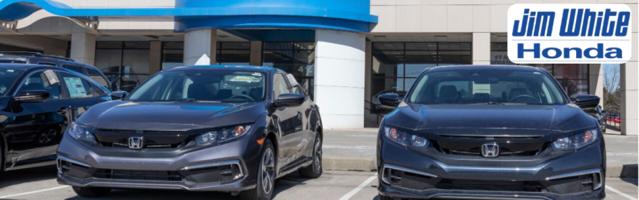 A wide selection of used vehicles parked at Jim White Honda's dealership lot in Toledo, OH.