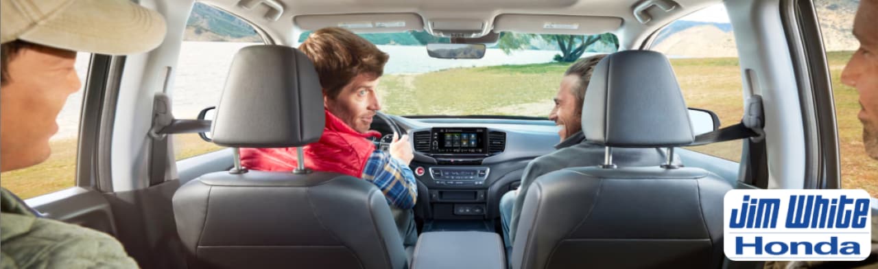 Driver enjoying the comfortable and tech-forward cabin of the 2026 Honda Ridgeline on a road near Maumee.