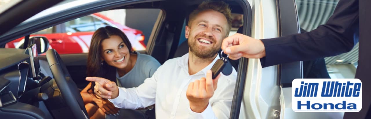 Jim White Honda staff member, is inspecting a customer's vehicle for trade-in appraisal in Toledo.
