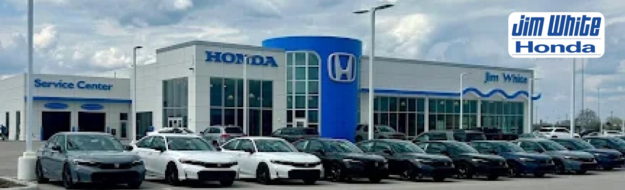 Jim White Honda dealership with Honda vehicles at display.