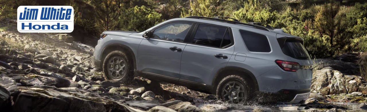 2025 Honda Pilot Touring parked at Jim White Honda, displaying a premium exterior and family-ready design