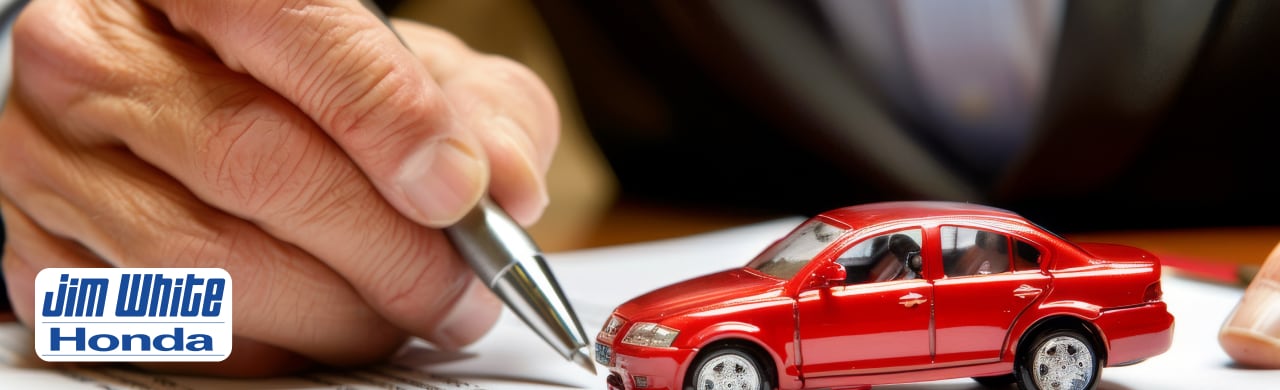 Trade-in specialist inspecting a customer's vehicle before helping them upgrade to a newer Honda at Jim White Honda.