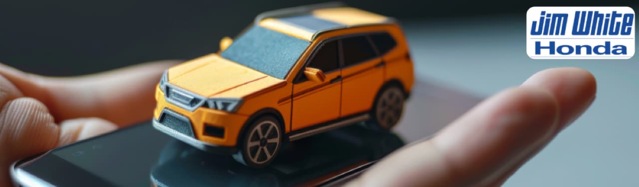 A customer exploring online with a service advisor inside Jim White Honda's modern service center in Maumee.