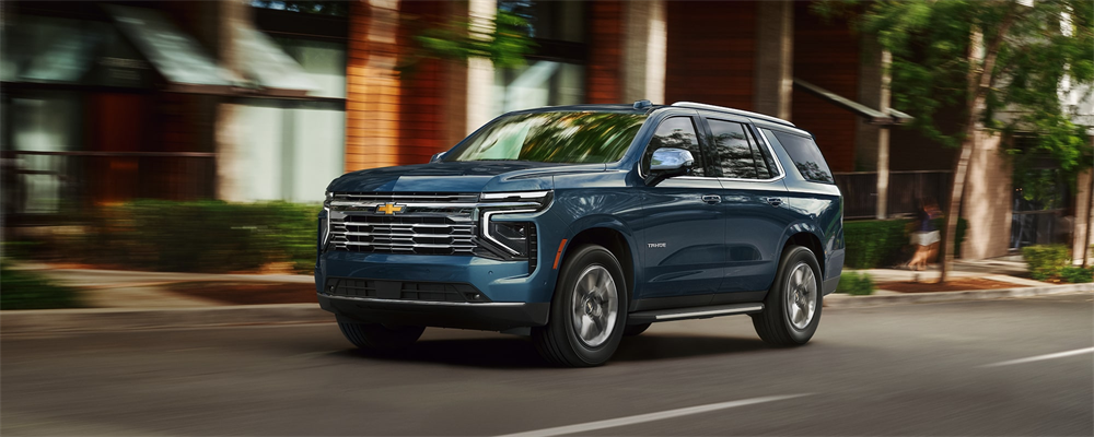 2026 Chevrolet Tahoe driving through city street.