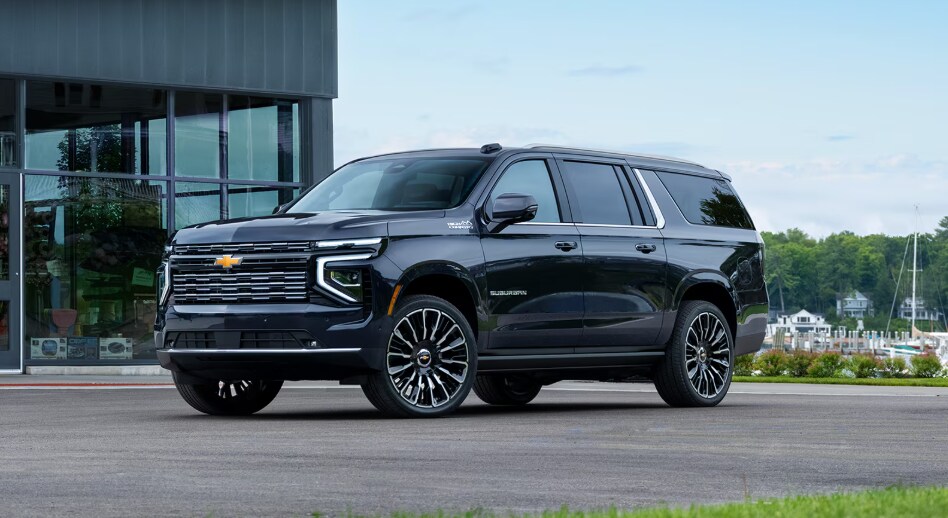 Black 2026 Chevrolet Suburban by boat loading dock.