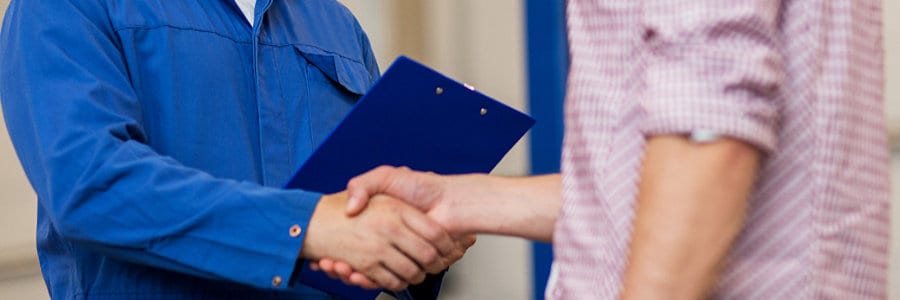 Mazda employee shaking hands with a customer