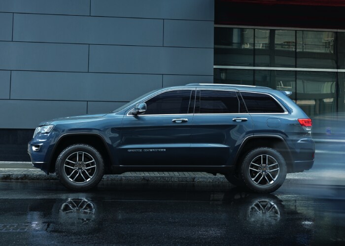 New Jeep Grand Cherokee New Jeep Grand Cherokee driving through the rain