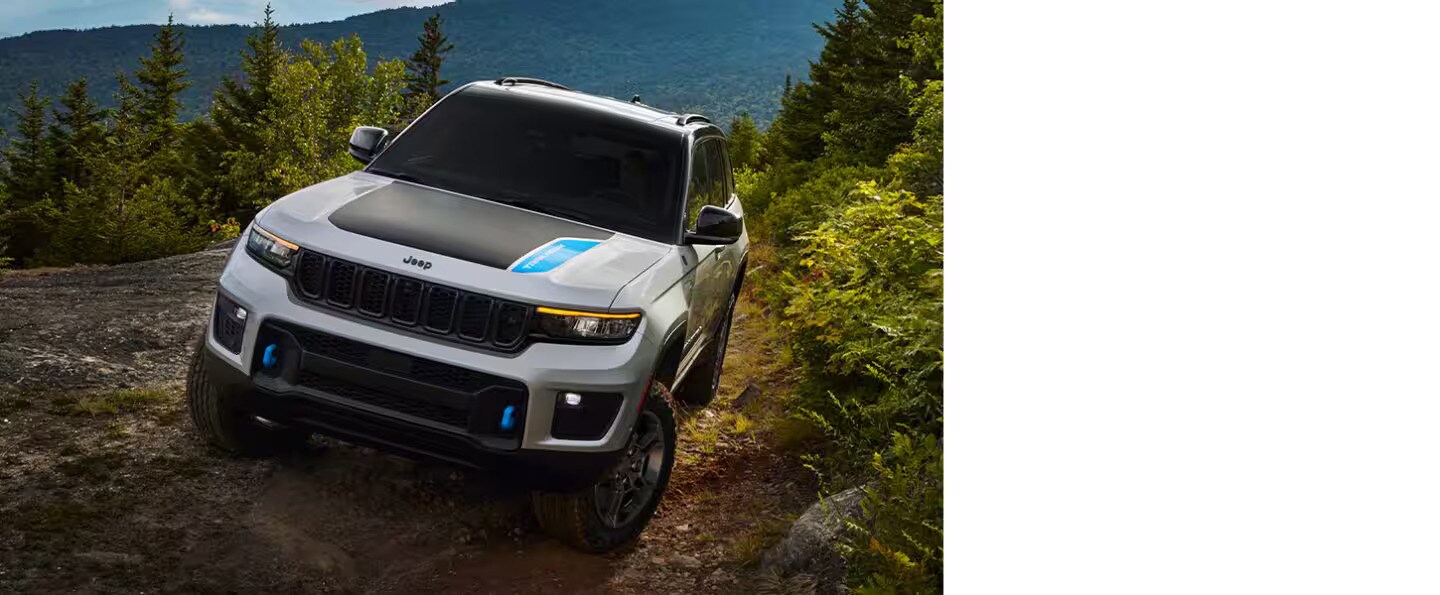 a white suv driving in the woods