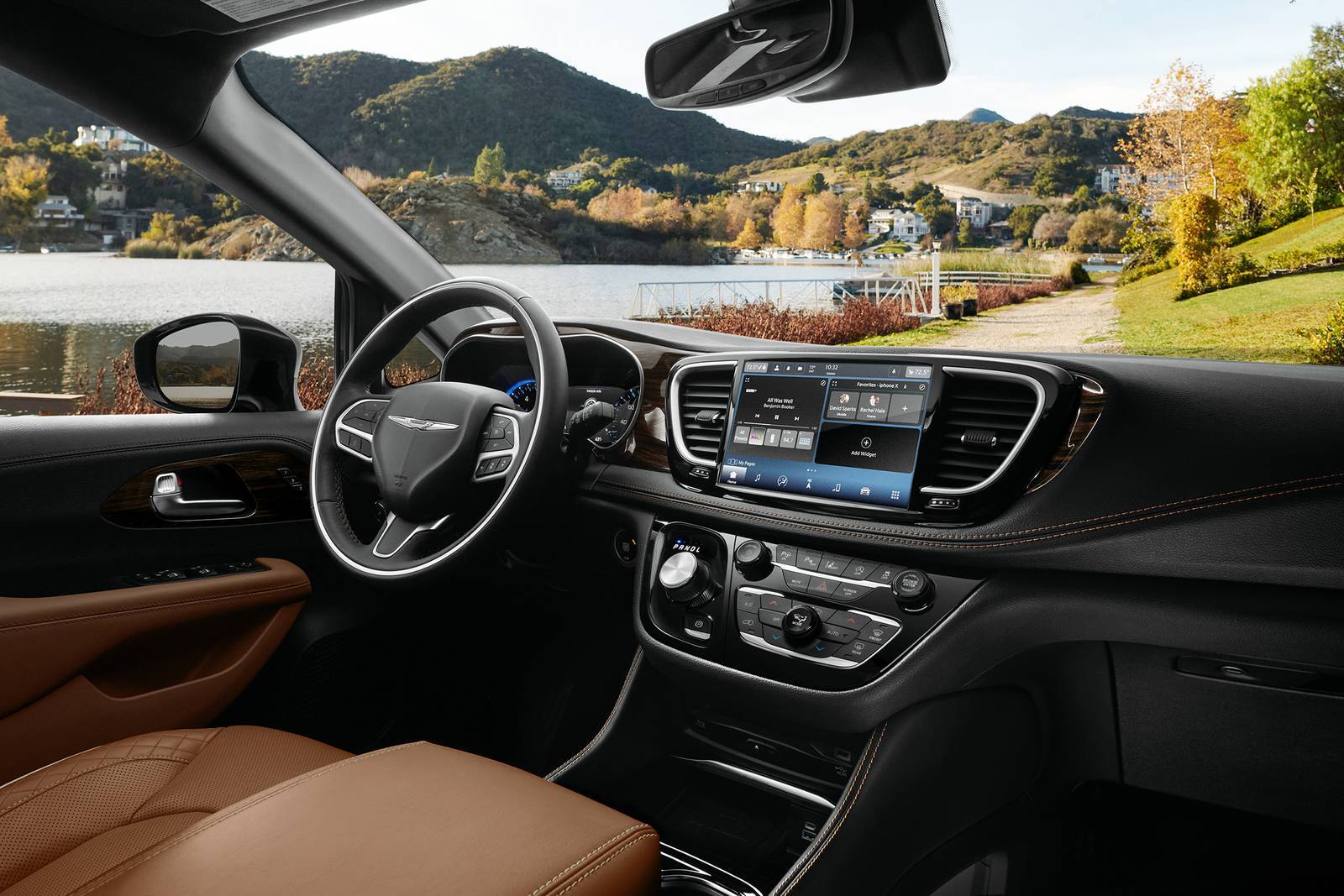 front passengers view of the front interior steering wheel and driver's area in a chrysler pacifica