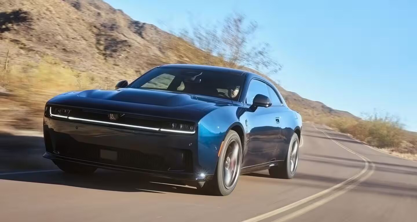 A blue car driving on the road.