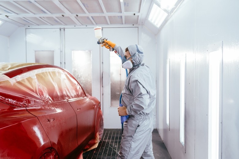 Mechanic painting a car