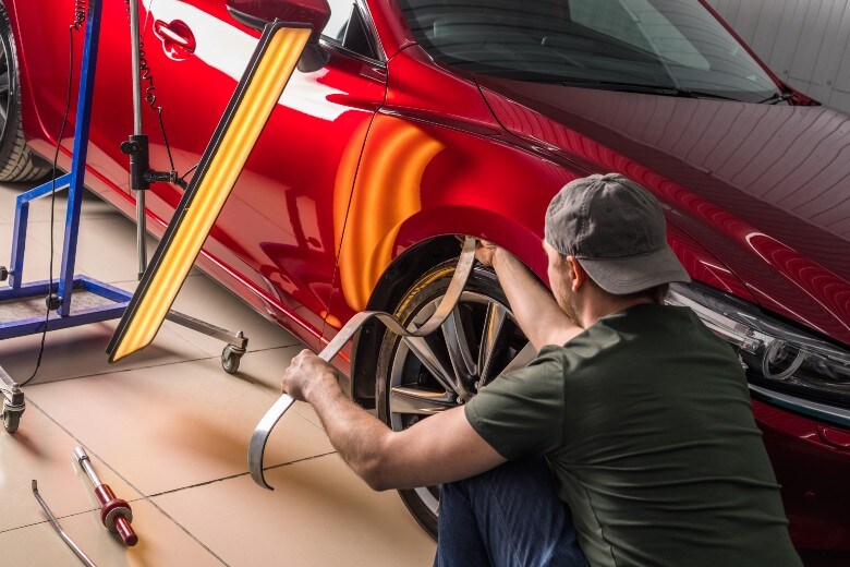 Mechanic fixing dent