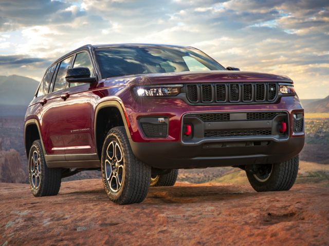 Exterior of a 2022 Red Grand Cherokee Summit on rocky ground