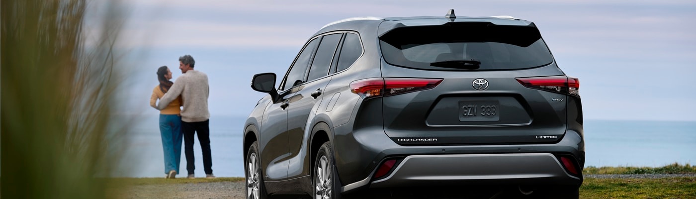 Grey Toyota Highlander Hybrid Limited parked in front of the ocean