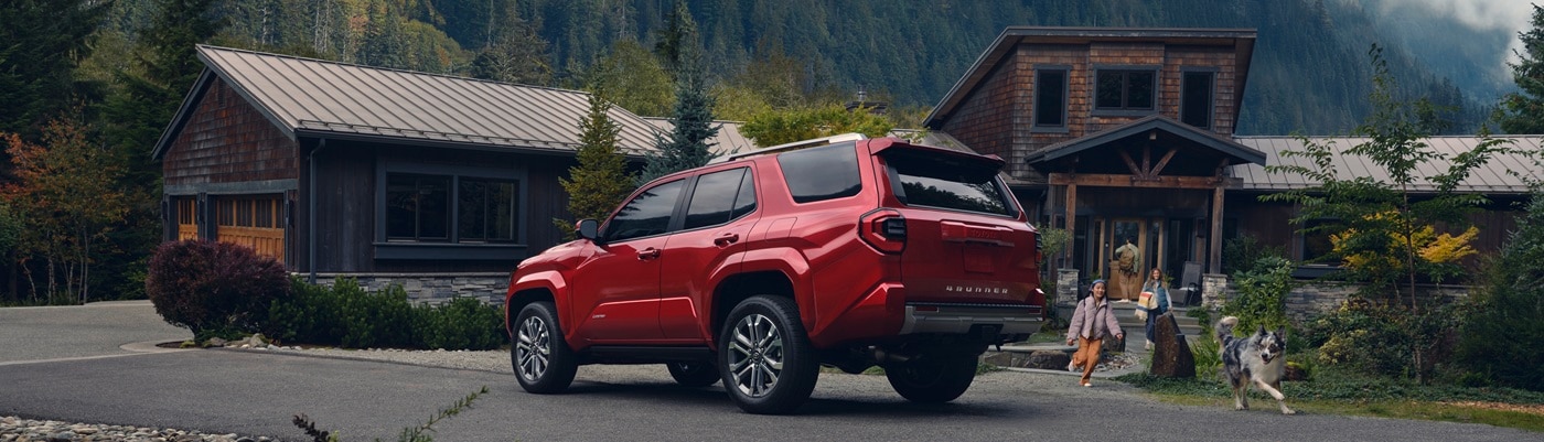 Red Toyota 4Runner Limited parked in front of a cabin