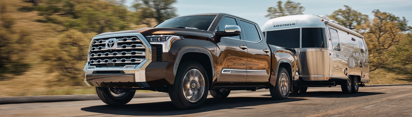 Brown Toyota Tundra 1794 Edition towing an Airstream trailer