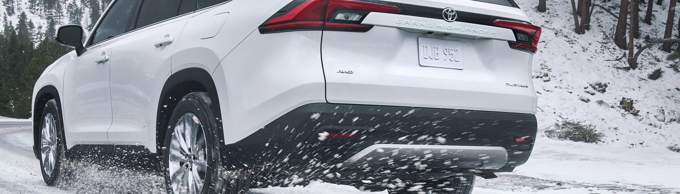White Toyota Grand Highlander Platinum driving in the snow