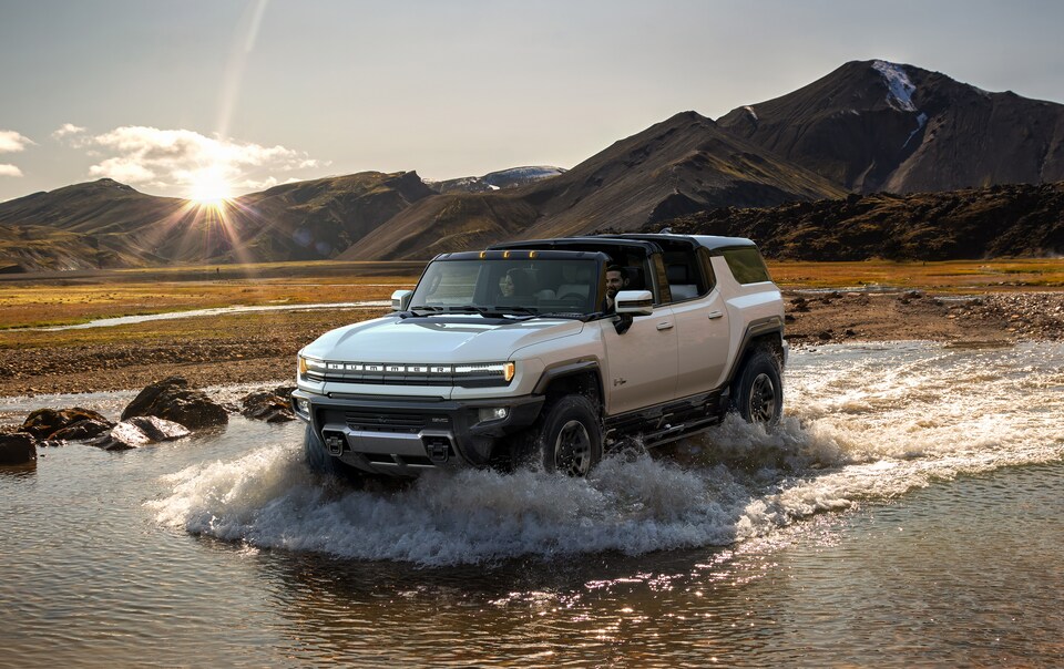  2025 Hummer EV SUV driving through water.