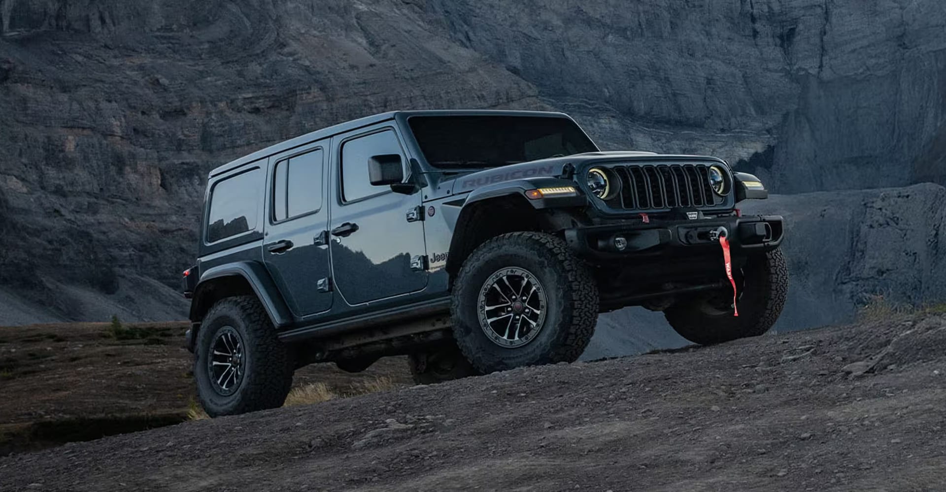 2026 Jeep Wrangler hero image showcasing the vehicle in rugged terrain