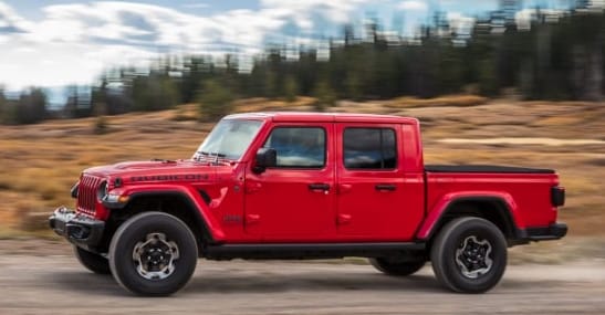 2020 Jeep Gladiator in Red Driving Down Street