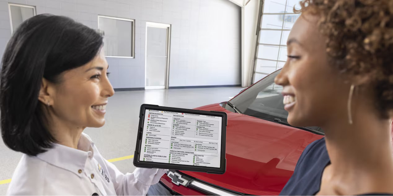 a view of a chevy service member talking to a customer about the multipoint services inspection