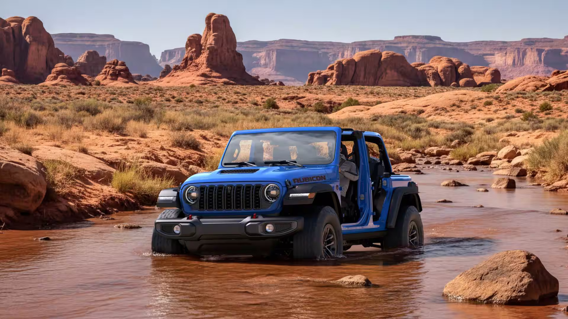 2027 Jeep Wrangler driving on an off-road trail