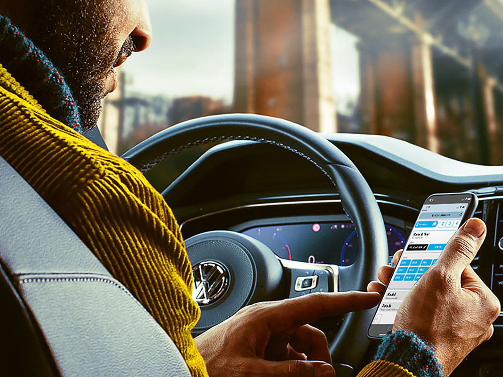 Person using a smartphone at the interior of a Volkswagen