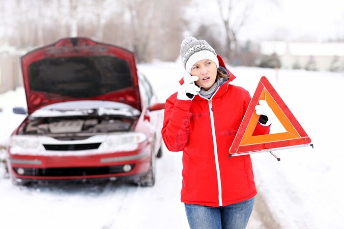 Woman_Having_Car_Trouble_In_Snow.jpg
