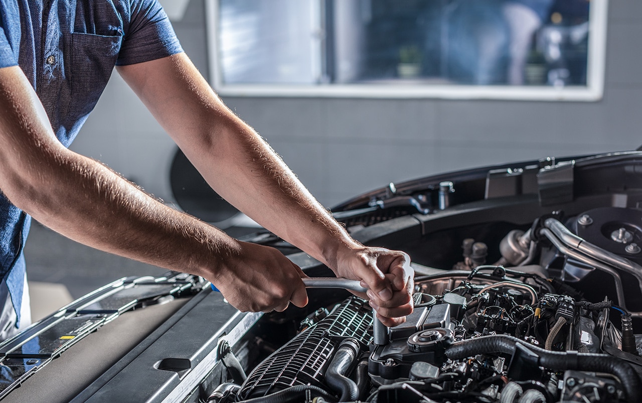 Man working under the hood of a car