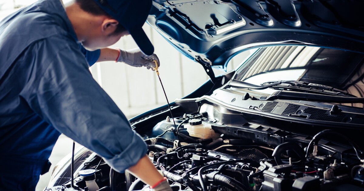 Technician performing an oil check Technician performing an oil check