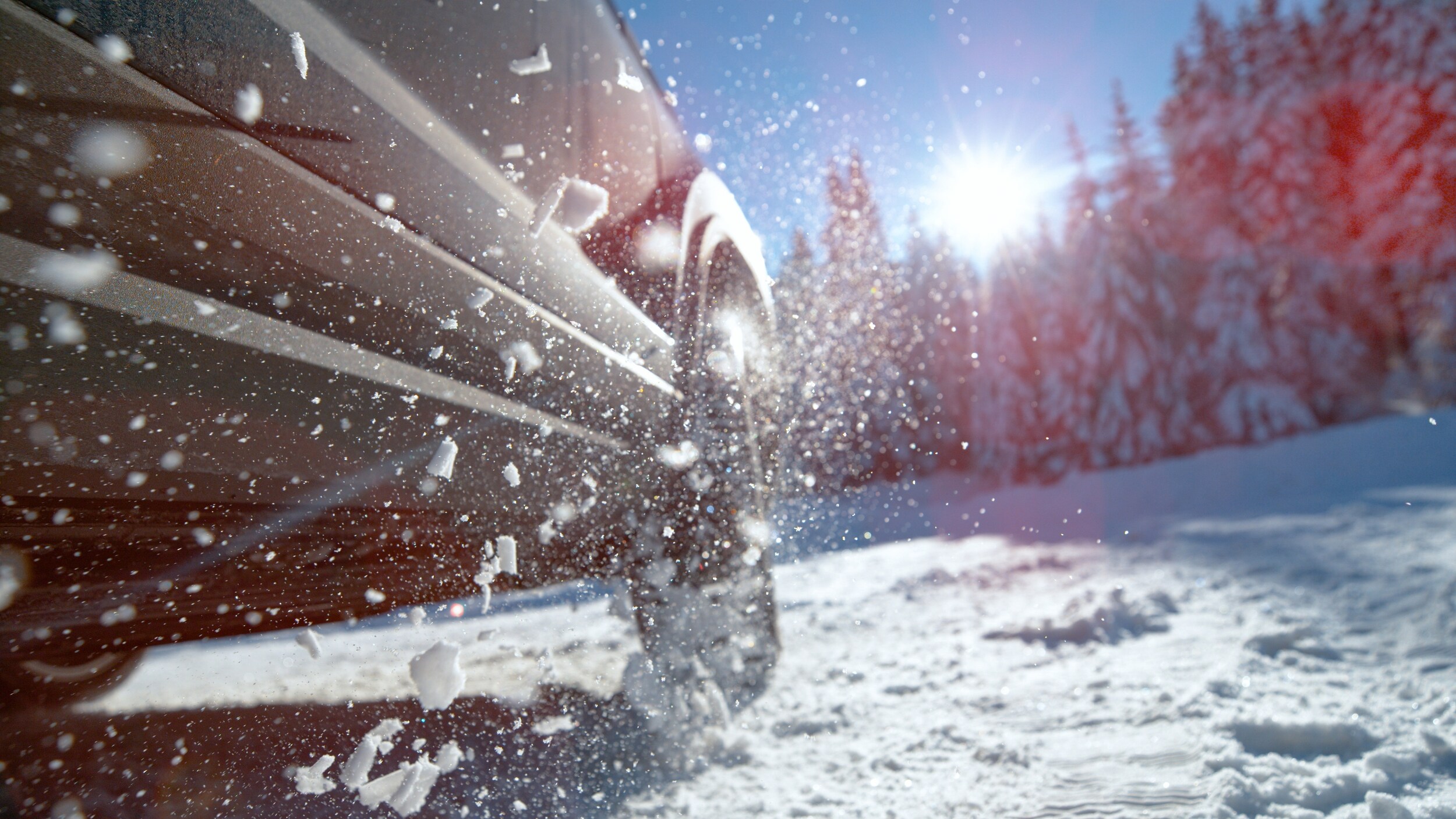 TITLE Close-up of tires driving over packed snow