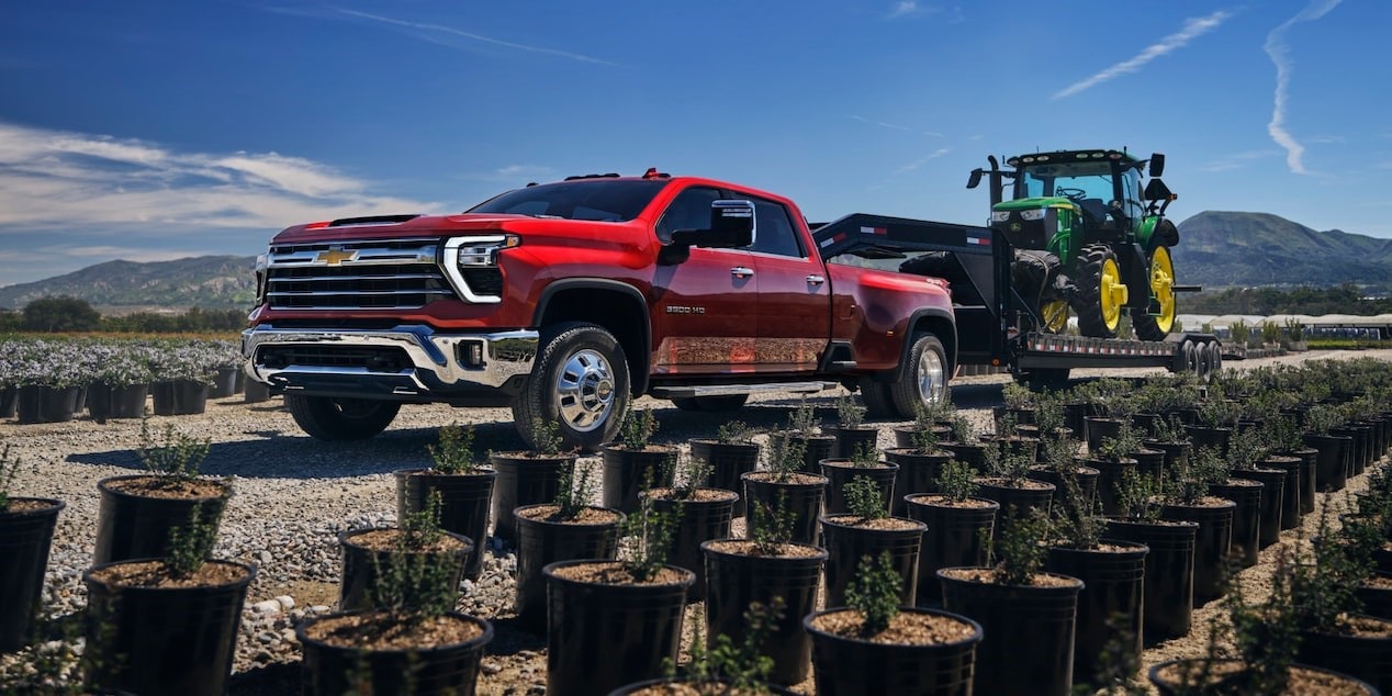 2025 Chevy Silverado HD towing a tractor through a nursery 2025 Chevy Silverado HD towing a tractor through a nursery