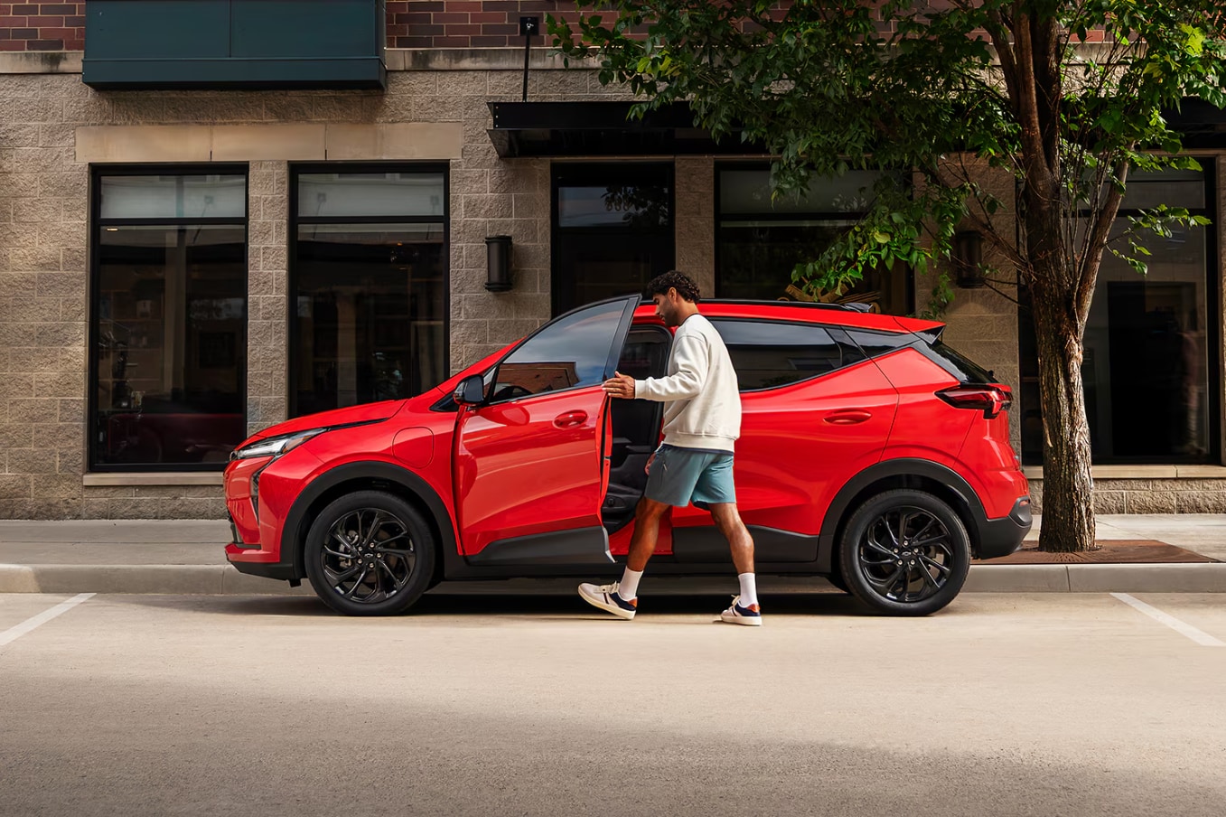 2027-Chevy-Bolt-EV-Owner-Opening-Driver-Door.png